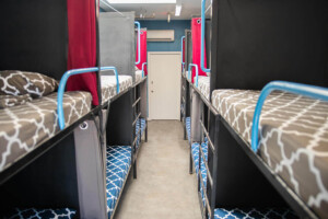 Shared dorm room with bunk beds and lockers at California Dreams Hostel