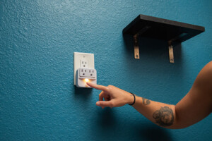 Personal power outlet and shelf beside a hostel bunk bed at California Dreams Hostel