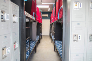 Shared dorm room with bunk beds and lockers at California Dreams Hostel in San Diego