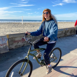 Traveler riding a bike near the beach in San Diego